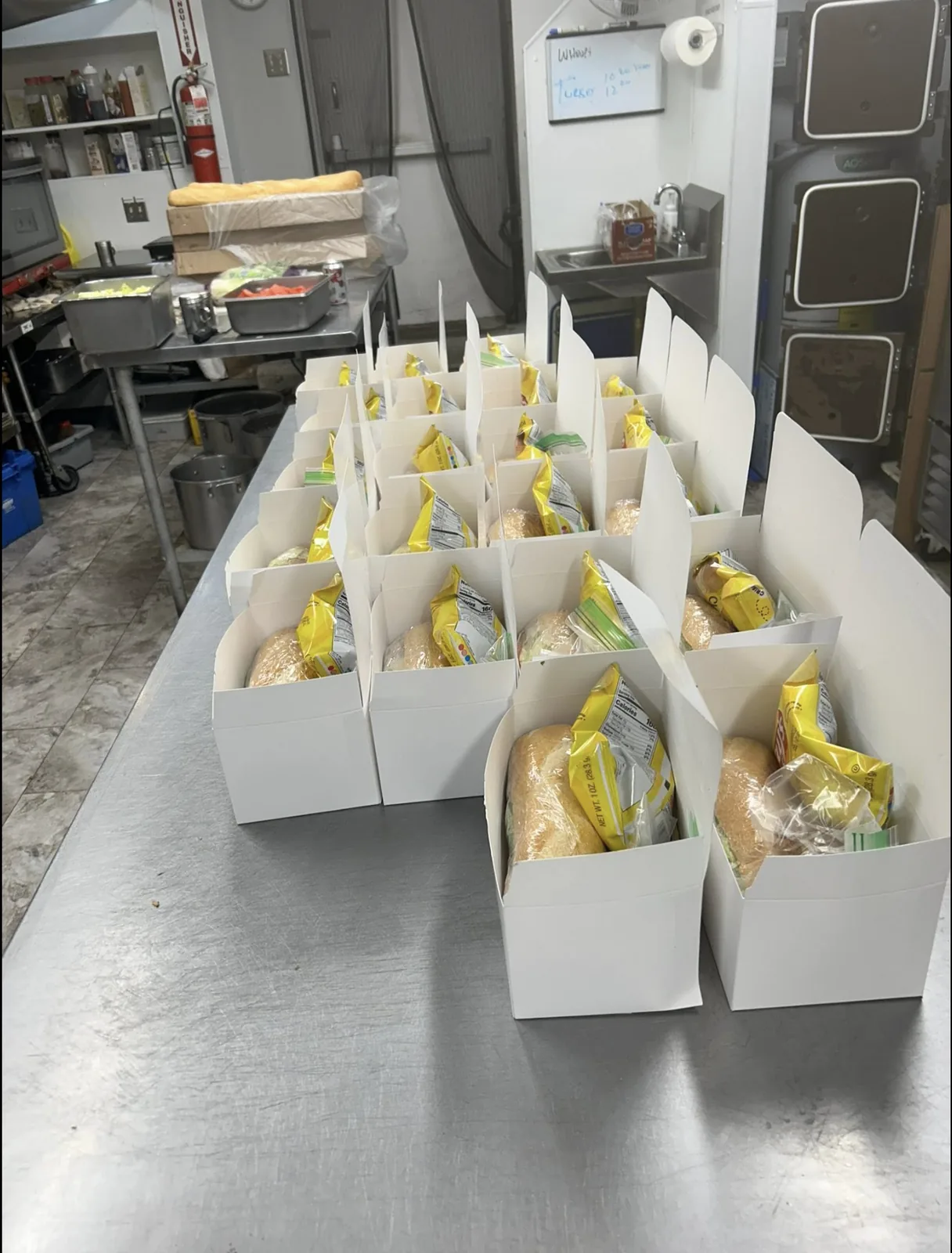 Custom boxed lunches packed and labeled for a visiting team